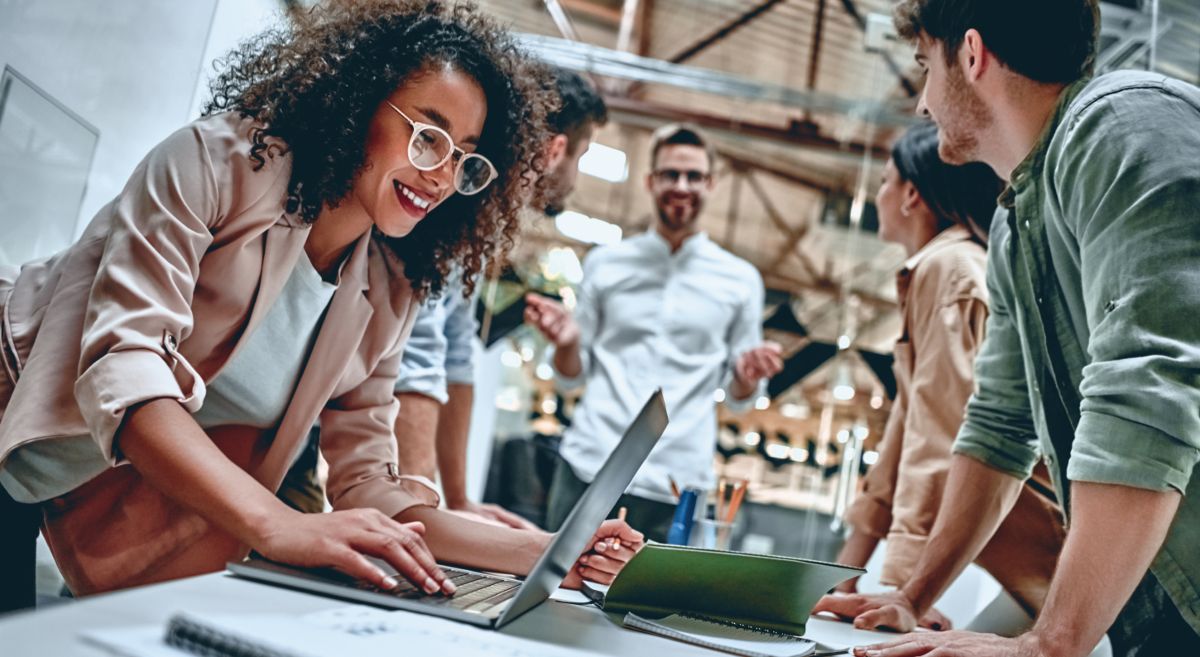 Professionals standing around table talking